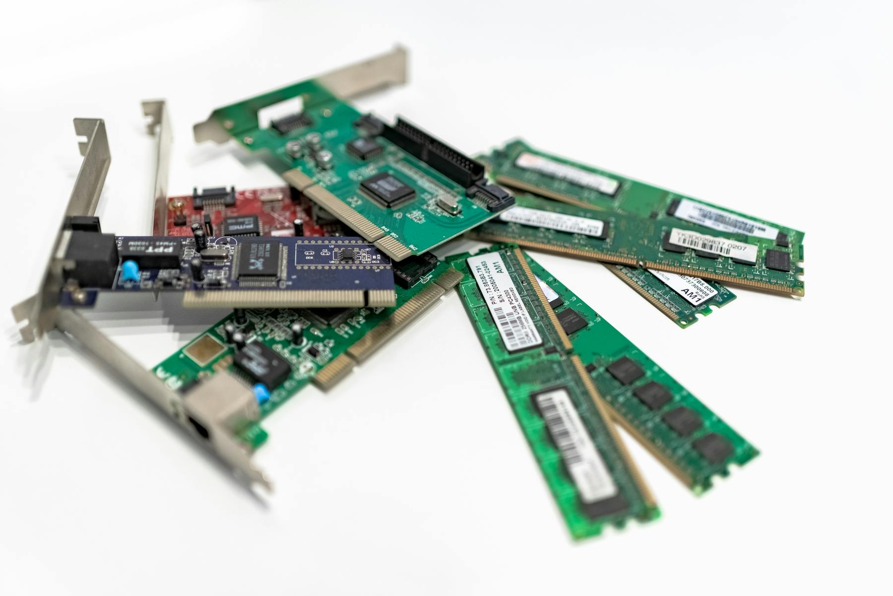 Pile of e-waste — PCI cards, RAM sticks, gold-fingered circuit boards ready for recovery